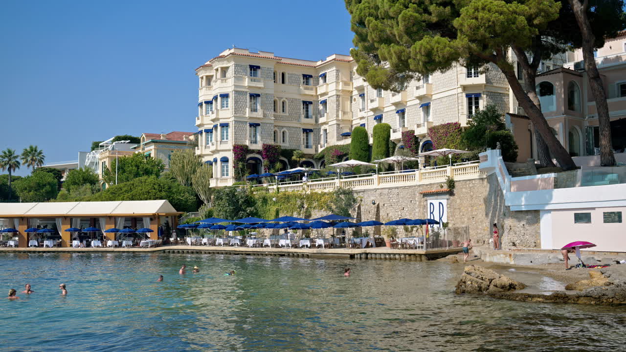 People swimming in the sea and relaxing on the beach in Juan-les-Pins, France