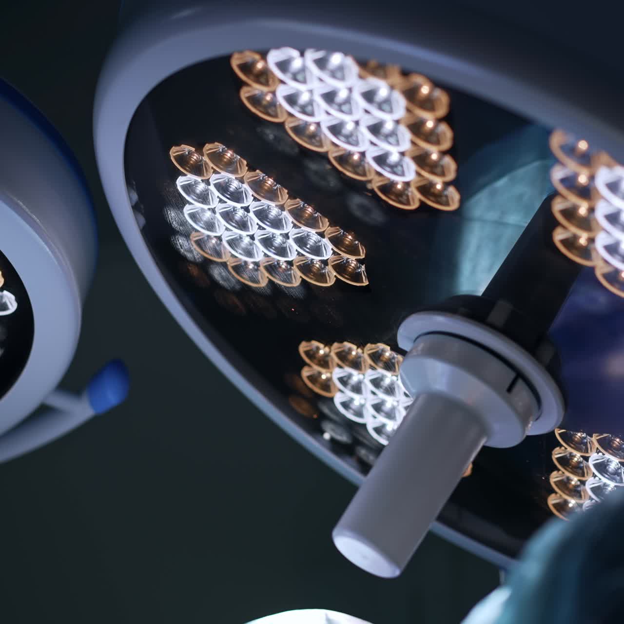 Switched on round lamps working in the surgery room. Illumination equipment is on during the operation. Low angle view