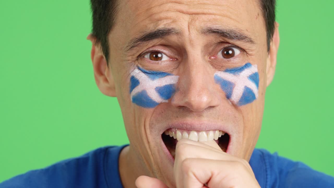 Very nervous man supporting scottish team during a difficult match