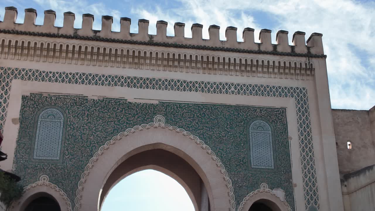Bab Boujloud, the Blue Gate of Fes, Morocco, with intricate tilework and a bustling entrance, establishing tilt down