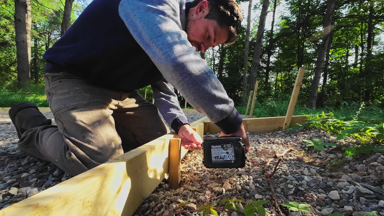 Close Up Shot Of A Carpenter Screwing Wood With A Battery Impact Driver Drill