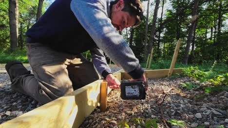 close up shot of a carpenter screwing wood with a battery impact driver drill