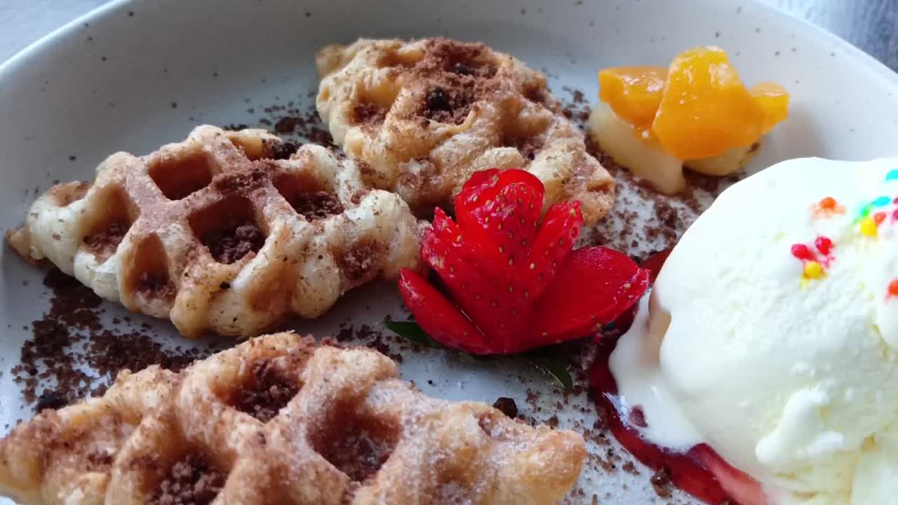 Waffles topped with ice cream, backward shot
