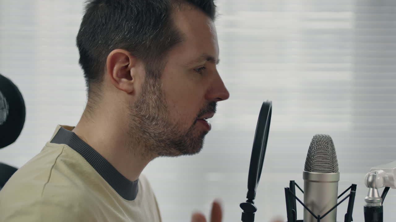 Person talking into a microphone, focused and engaged in a conversation or recording