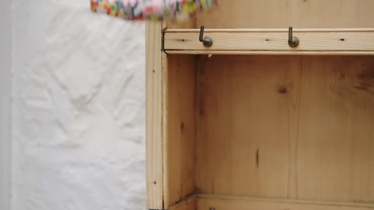 Female hand picking up floral face mask and car keys, going out and leaving house in new normal concept, closeup
