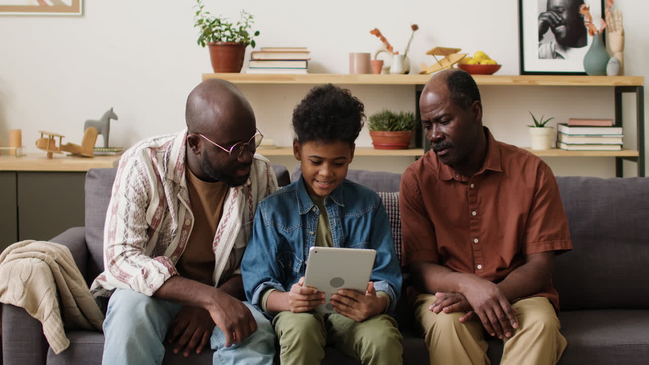 Boy playing video games with family