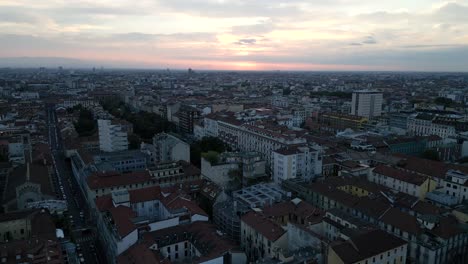 aerial drone footage captures milan's capital city at sunset, showcasing its iconic architecture, bustling streets, and golden hues blending with the urban skyline.