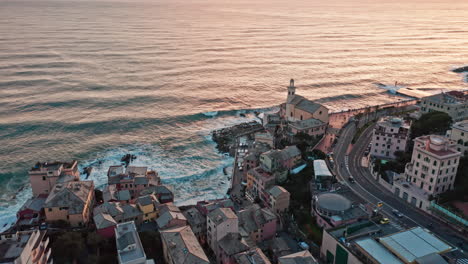 High-angle-drone-view-over-Boccadasse-coastline-in-Genova-during-golden-sunset