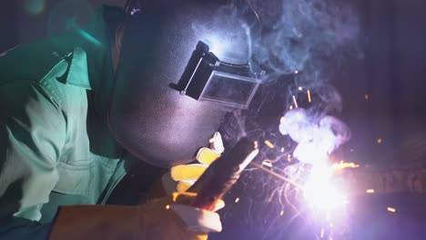 metal welder working with arc welding machine