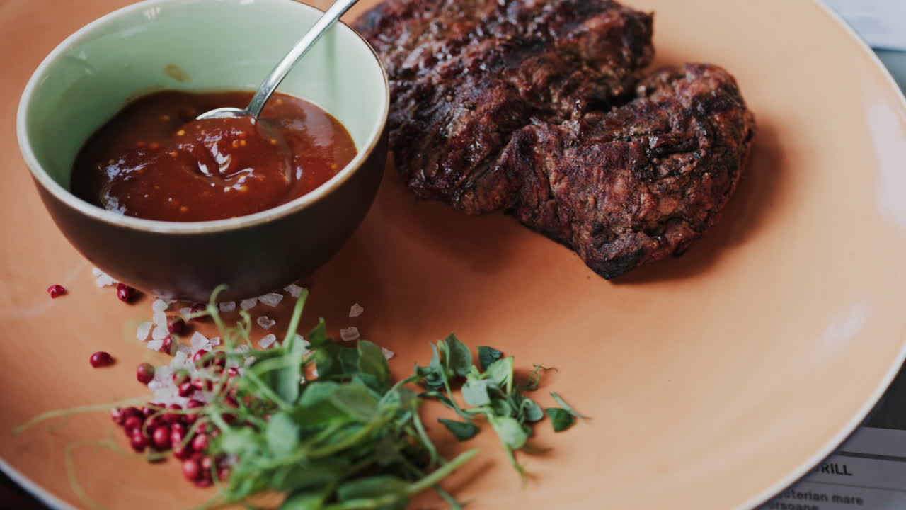 Close up of a Sirloin Steak with Barbecue Sauce and micro-plants on the side