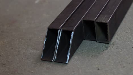 angle cut metal frame pipes on ground after fabrication, closeup
