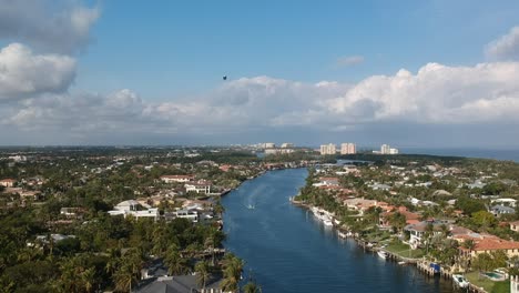 aerial shot defending along the intercostal in florida with a blimp near by