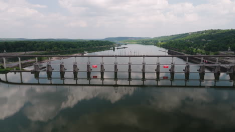 mirrored reflections of big dam bridge on the waters of arkansas river in north little rock, arkansas