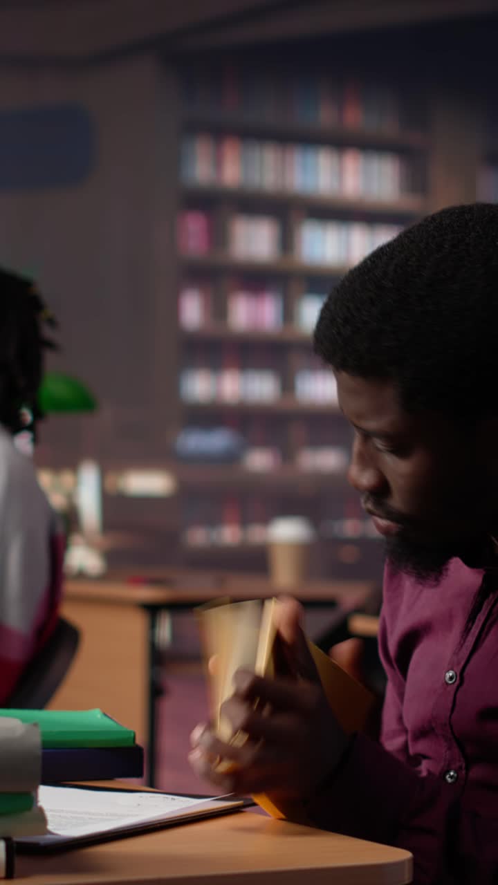 Vertical video african american guy highlighting essential handwritten class notes