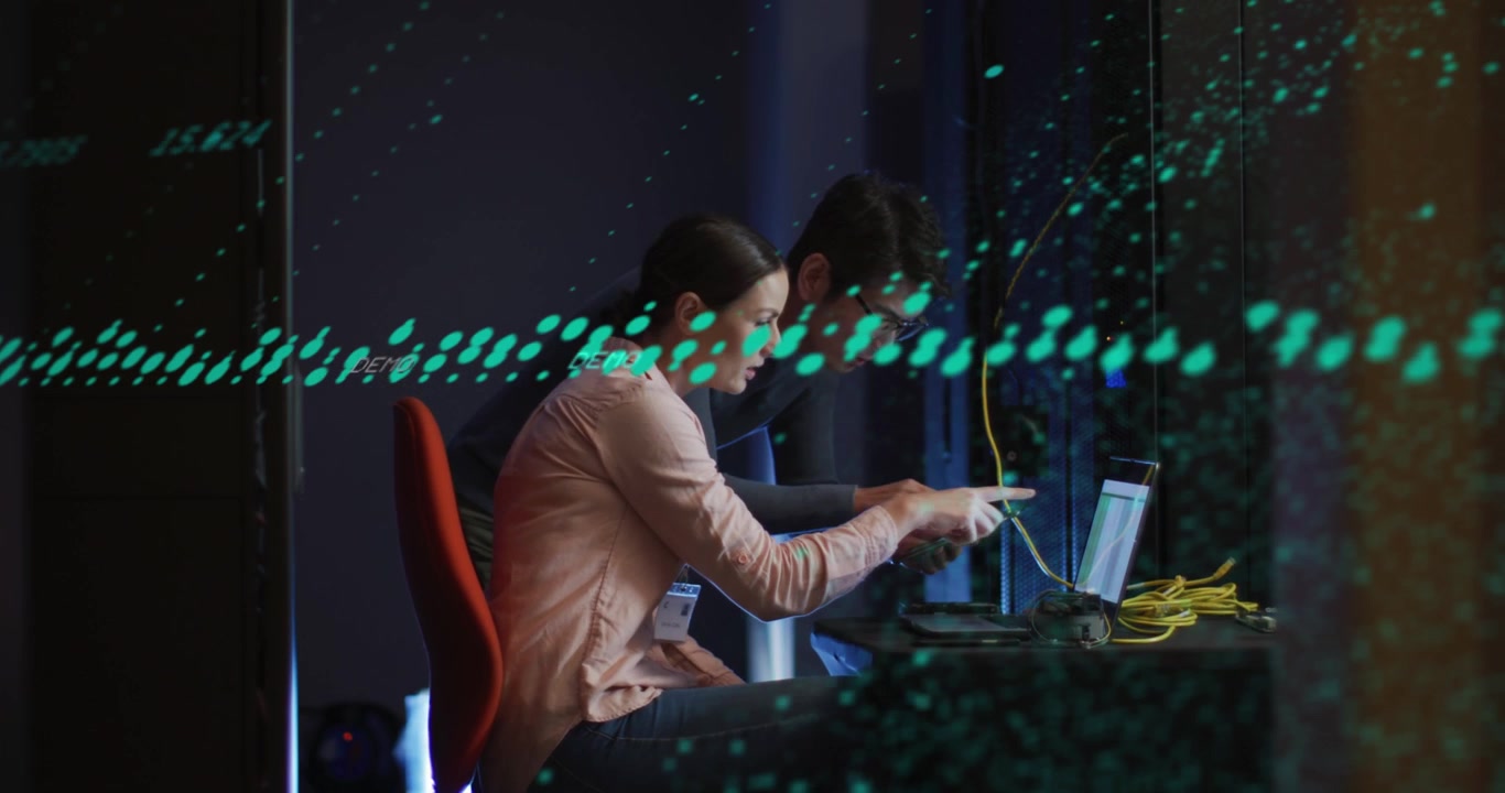 IT Professionals Collaborating on Server Maintenance in Data Center