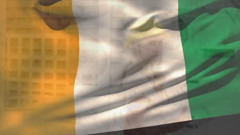 animation of flag of ivory coast waving over smiling caucasian female architect in hard hat