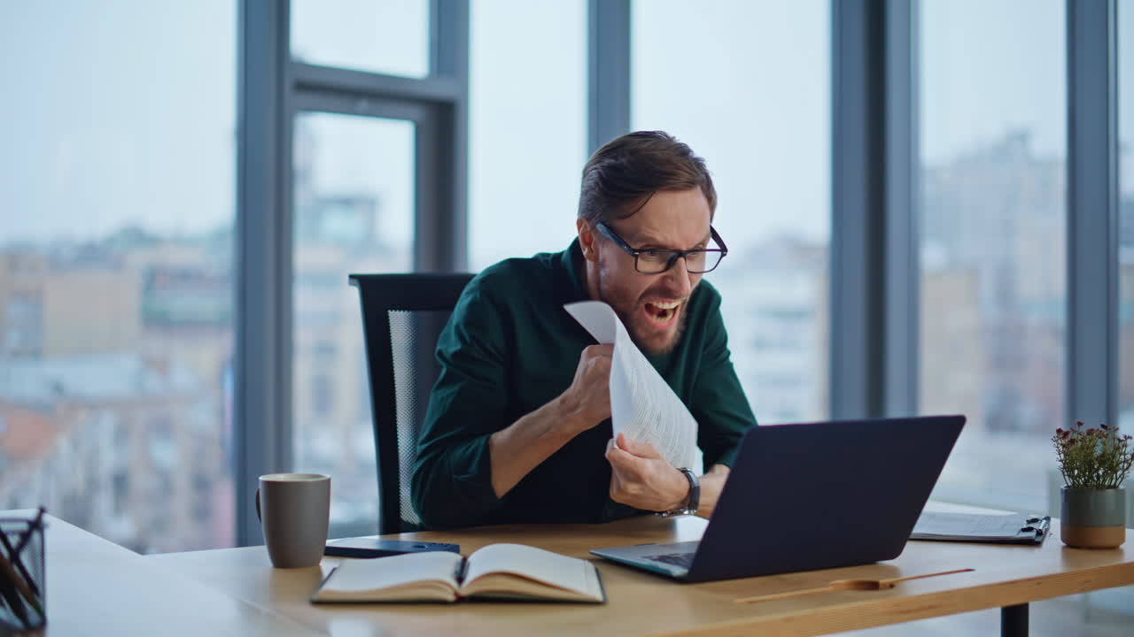Angry ceo arguing video conference holding business documents at office ...