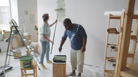 couple painting a wall in their home