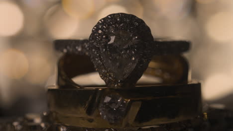 impresionantes anillos de compromiso y de boda de diamantes halo con acentos de diamantes negros y un diamante central en forma de pera