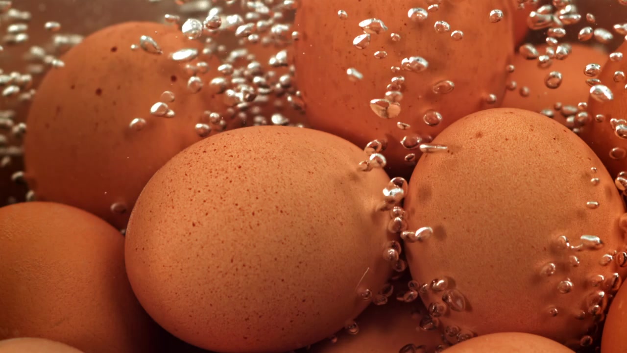 Brown Eggs Boiling in Hot Water with Bubbles