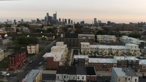 north philadelphia drone launching from roof top to reveal philly skyline during dusk on an overcast cloudy day