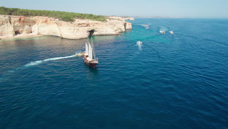 wonderful aerial view of the coast of benagil and boats touring the caves