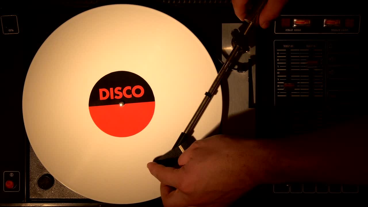 A retro-styled film look of a spinning record player 4k.