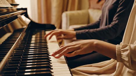 two people playing piano