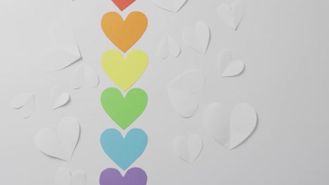 Video-of-colorful-paper-hearts-lying-on-white-background