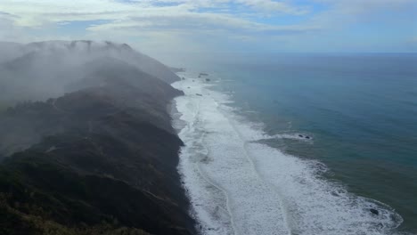 rugged coastline lost coast trail usal beach campground 4wd black sand mist rain fog aerial drone california pnw sun rays waves crashing cloud layer morning chimney rocks circle right