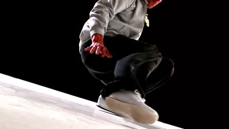 cool young break dancer dancing on black background