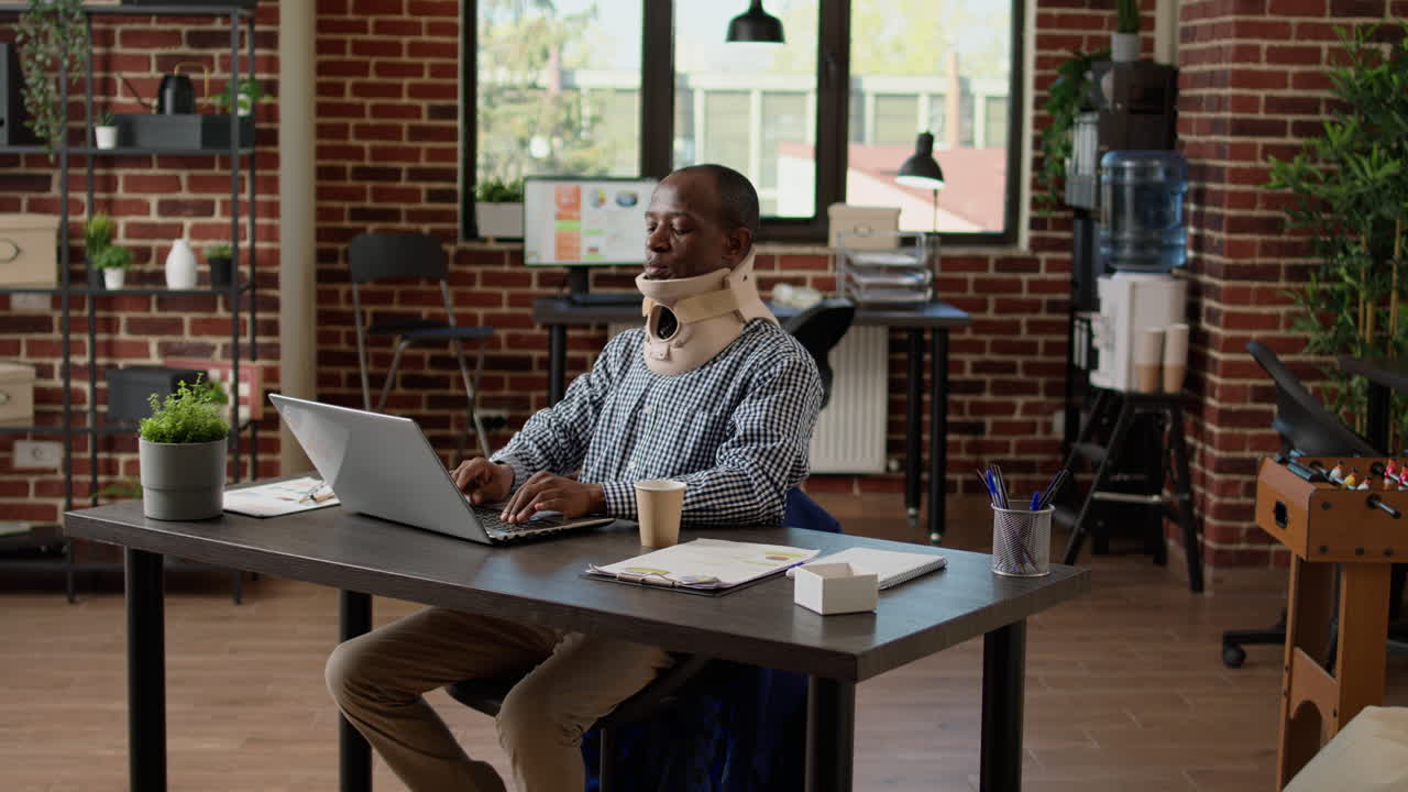 African american businessman wearing medical cervical neck collar foam after physical injury