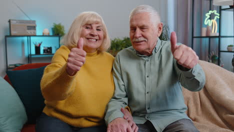 Happy-senior-family-looking-approvingly-at-camera-showing-thumbs-up,-like-positive-sign,-good-news