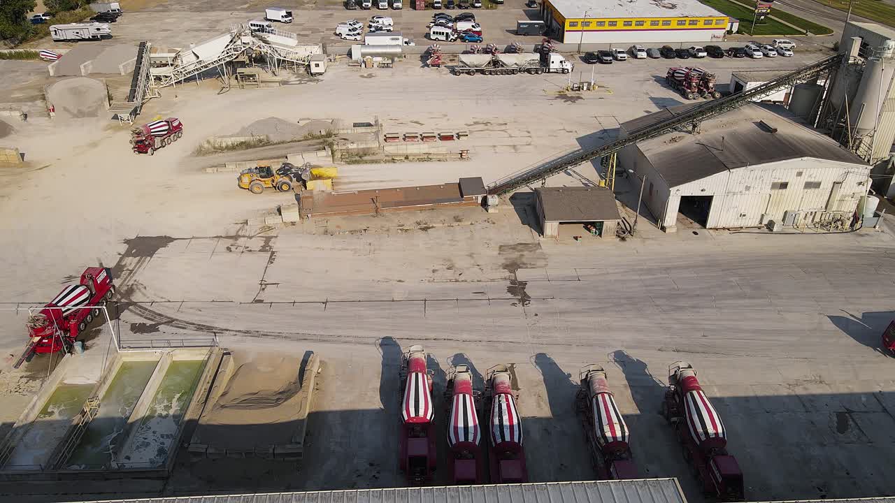 Aerial view of a concrete plant with cement trucks and industrial equipment