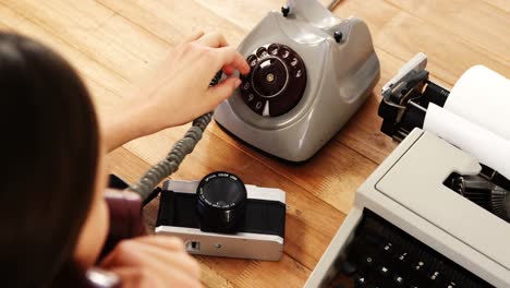 mujer de negocios usando un teléfono antiguo