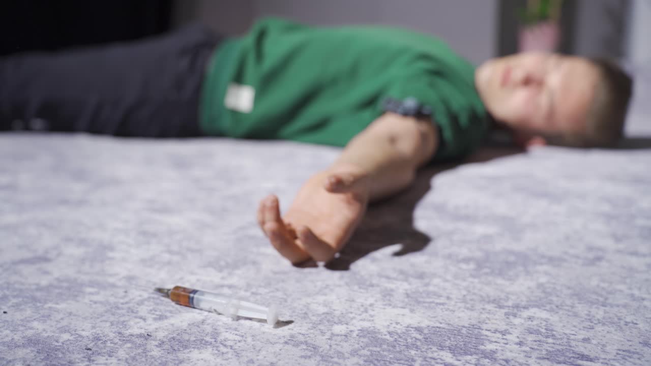 Drug addicted man is unconscious from overdose.