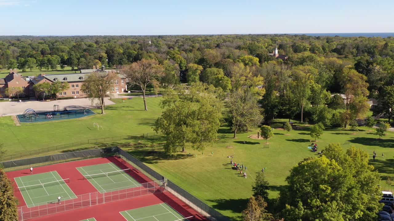Aerial view of kids playing soccer in a park next to a tennis court. Taken in Fox Point Wisconsin