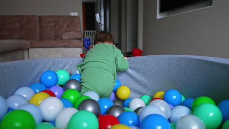 baby playing in a ball pit