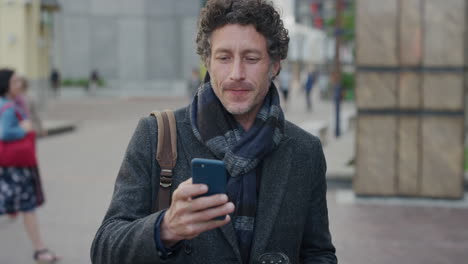 portrait happy mature businessman using smartphone texting enjoying browsing online messages on mobile phone drinking coffee in city slow motion