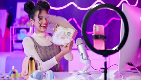 woman unboxing product in vlogging studio