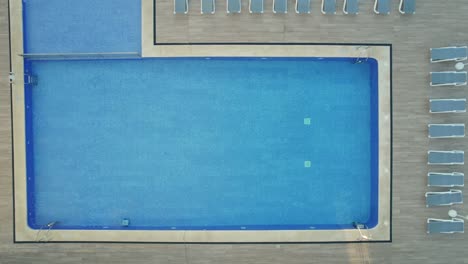 Down-to-up-drone-view-of-swimming-pool-of-Globales-lord-Nelson-hotel-in-Balearic-Islands,-Spain