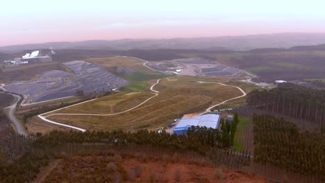 Aerial-View-Over-Factory-Building-On-Edge-Of-Landfill-Site-In-Galicia,-Spain