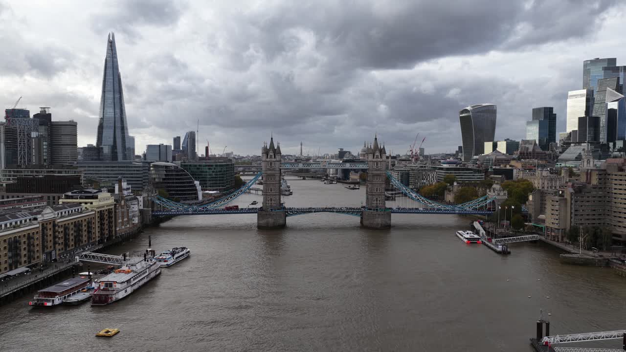 Tower bridge in London, The United Kingdom. Monumental iconic bridge over the thames river. Aerial drone video on cloudy day