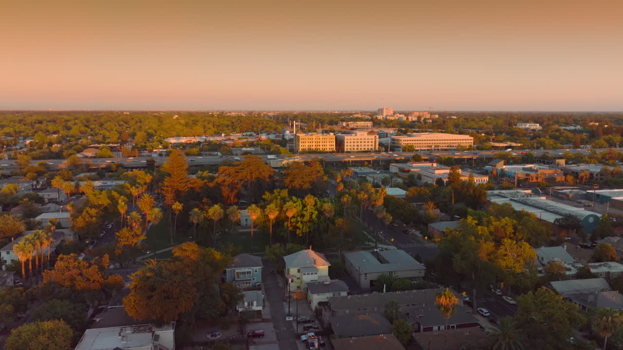 Lively traffic by the road in Sacramento, California, United States. Beige color sky at backdrop. Aerial view.