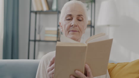 senior woman reading a book at home