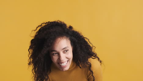 african american positive woman over orange background.