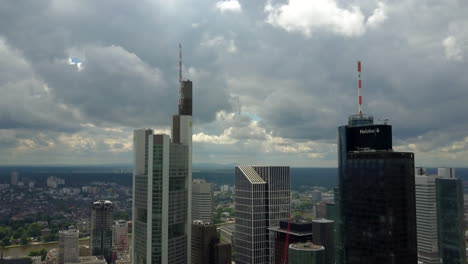 AERIAL:-Close-up-of-Frankfurt-am-Main,-Germany-Skyline-with-Clouds,-cloudy