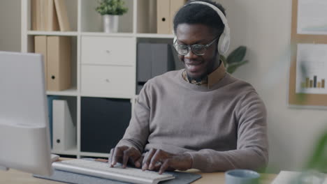 man working on a computer in an office