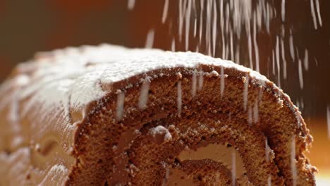 powdered sugar on chocolate roll cake