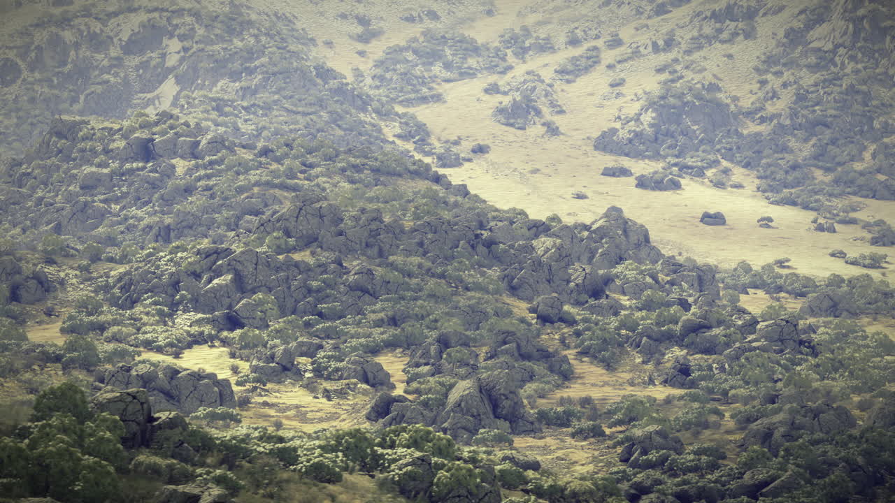 Scenic view of rocky landscape with lush greenery under cloudy sky